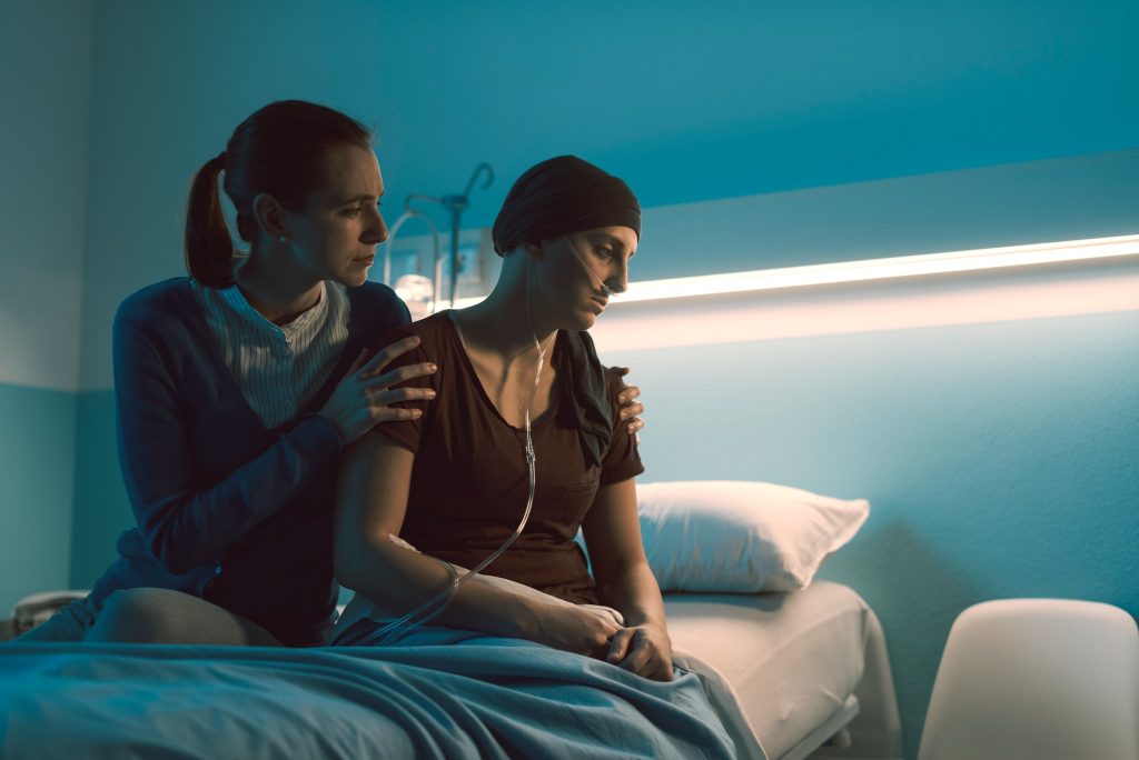 Woman assisting her friend with cancer at the hospital